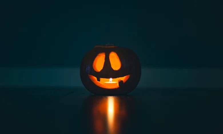 spooky October events glowing jack-o'-lantern pumpkin with a candle inside, symbolizing the spirit of Halloween and fright festivals.