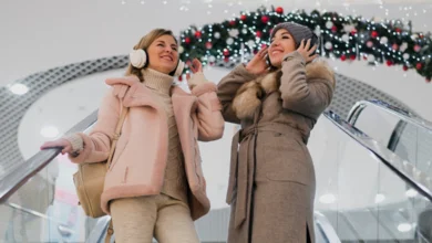 Metro Vancouver holiday kickoff with two women in winter coats enjoying festive decorations and lights in a shopping mall