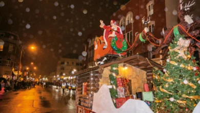 Abbotsford Christmas Parade 2025 float with Santa, reindeer, and decorated Christmas tree moving through a lit downtown street at night