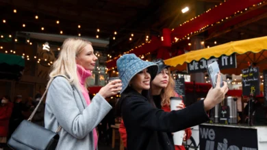 Winter night markets across the Fraser Valley with people enjoying hot drinks and taking photos at a festive market