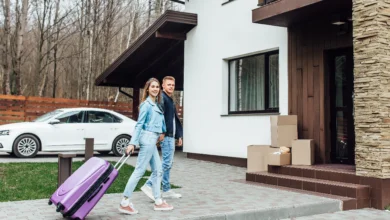 rentals near me couple arriving at new rental home with luggage in Canada