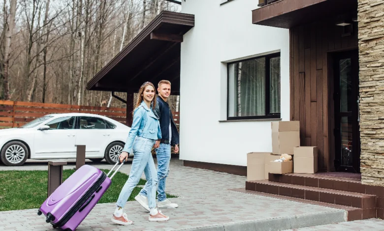 rentals near me couple arriving at new rental home with luggage in Canada
