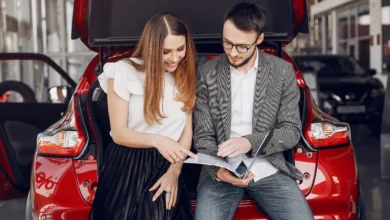 used cars in Canada buyers reviewing vehicle documents before purchase at dealership