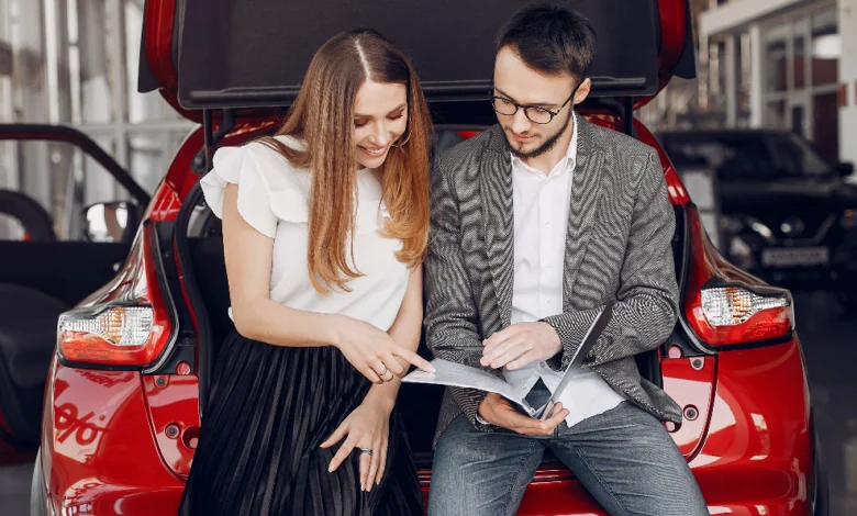 used cars in Canada buyers reviewing vehicle documents before purchase at dealership