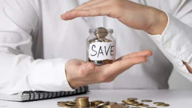 Person protecting savings jar representing emergency fund in Canada for financial security