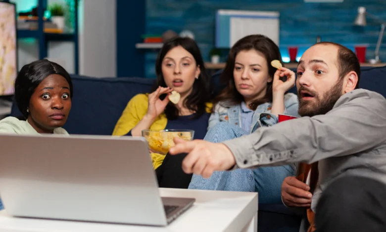 Friends watching top trending Netflix & OTT shows in Canada right now on a laptop while reacting to a dramatic scene