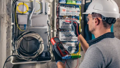 Emergency Electrician inspecting a residential electrical panel with a digital multimeter