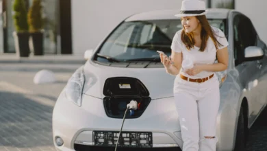 Woman charging an electric vehicle representing Future Electric SUVs and sustainable transportation