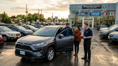 South Asian couple inspecting a used SUV at a Canadian dealership before buying