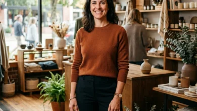 Confident local business owner standing inside a modern independent store with warm natural lighting and welcoming interior.