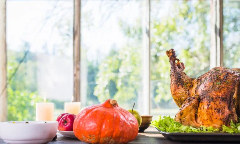 Roasted Thanksgiving turkey with pumpkin and apples on a table